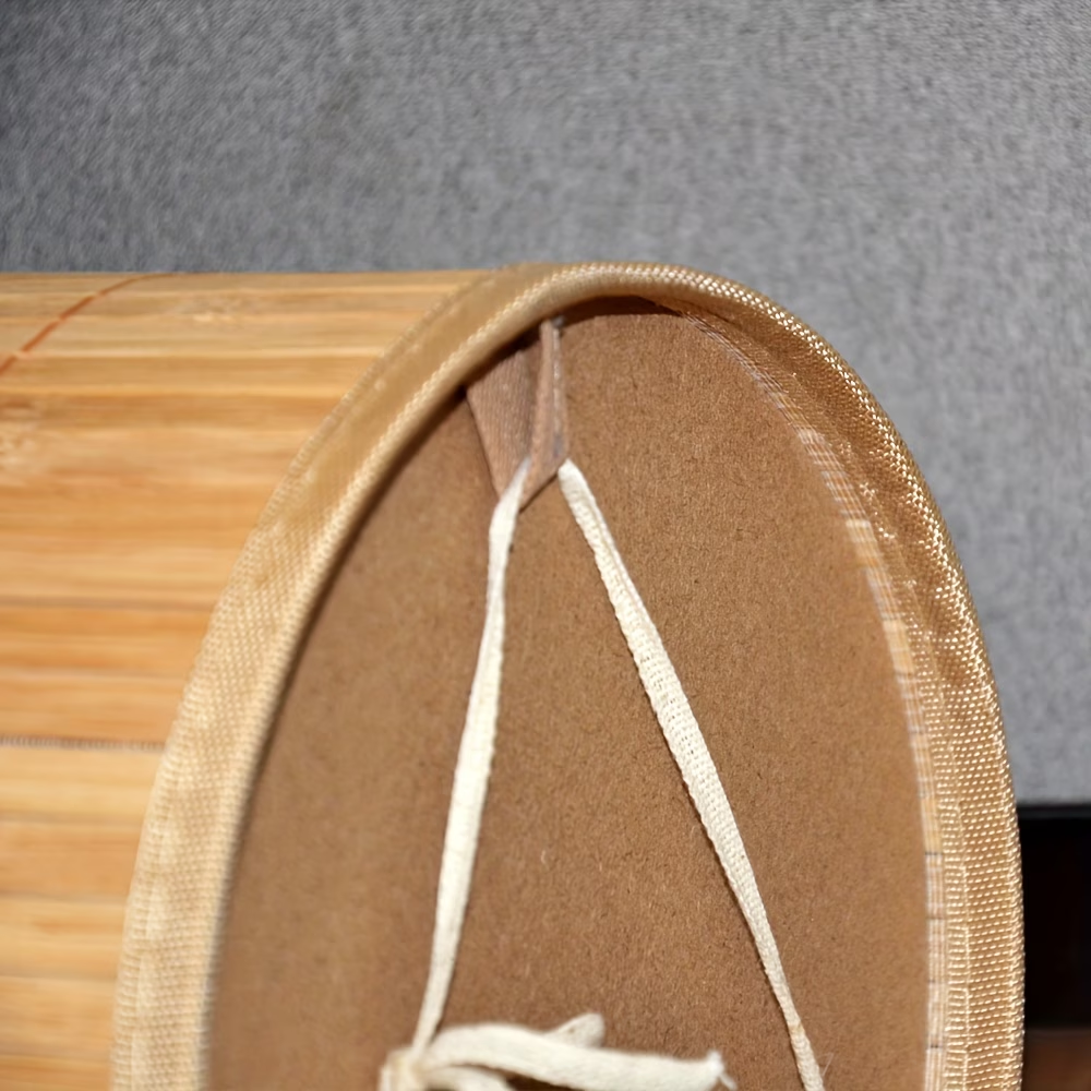 A rustic-style trash can, made of bamboo, with a minimalist design.