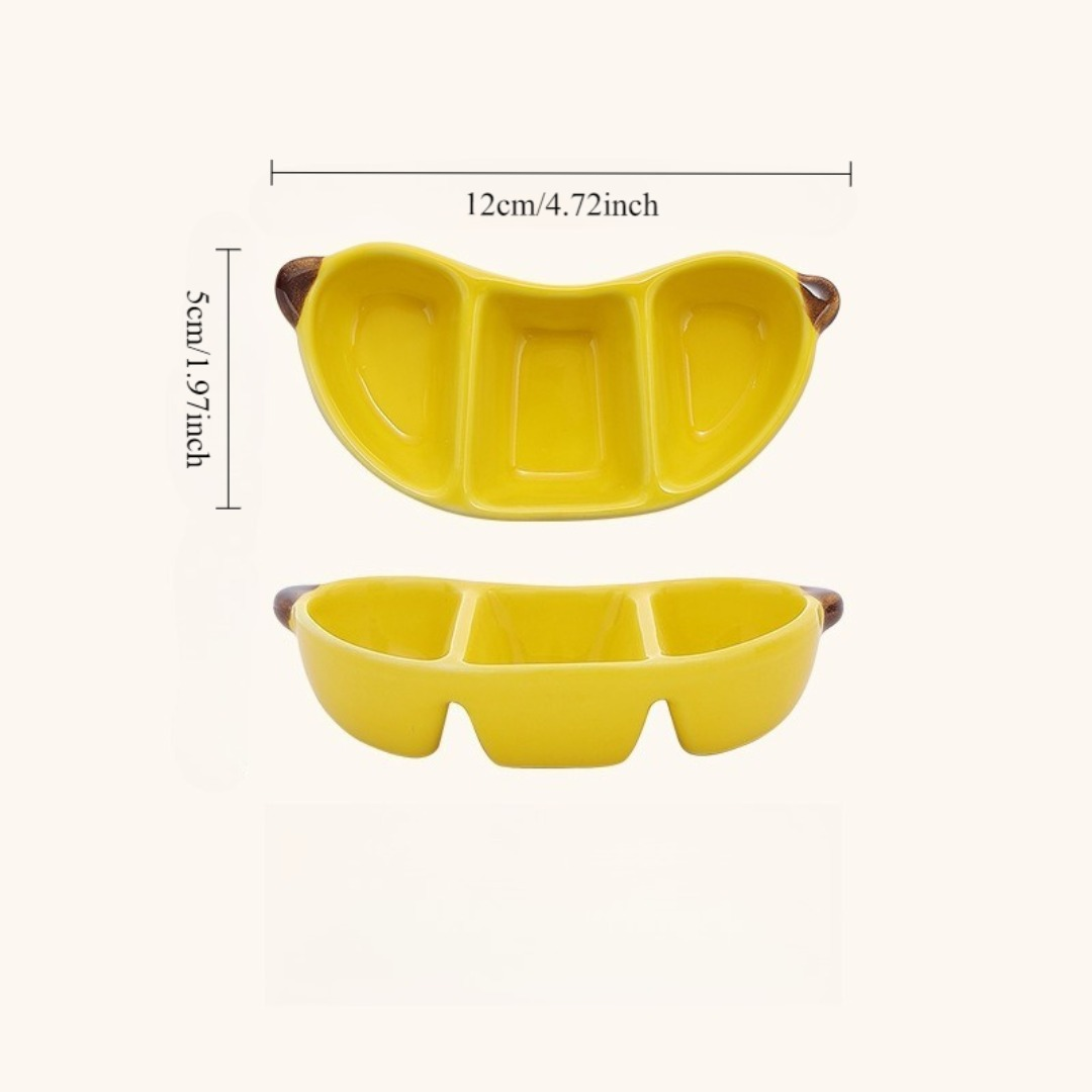 A ceramic fruit-shaped dipping dish - with a bright yellow and red design.