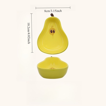A ceramic fruit-shaped dipping dish - with a bright yellow and red design.