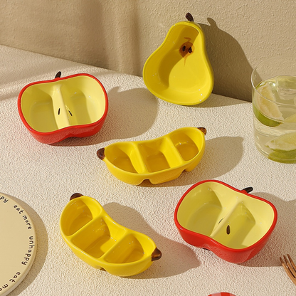 A ceramic fruit-shaped dipping dish - with a bright yellow and red design.