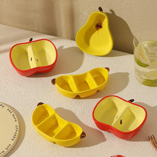 A ceramic fruit-shaped dipping dish - with a bright yellow and red design.