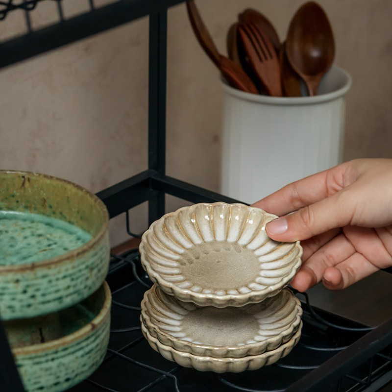 Two square yellow retro-style petal-shaped condiment dishes