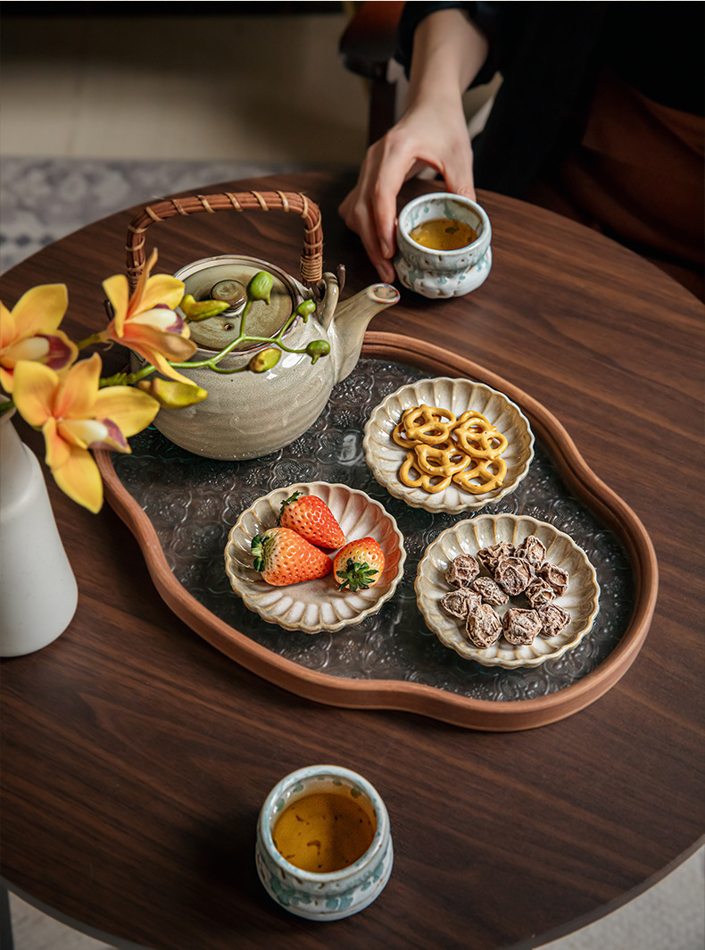 Two square yellow retro-style petal-shaped condiment dishes