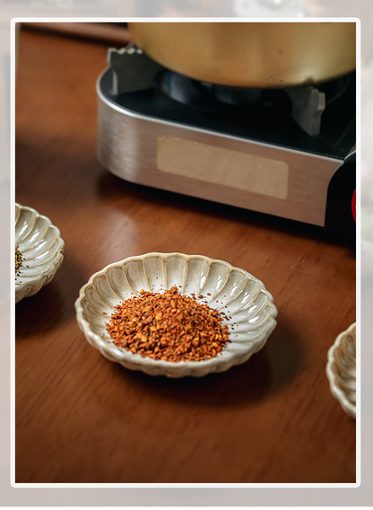 Two square yellow retro-style petal-shaped condiment dishes